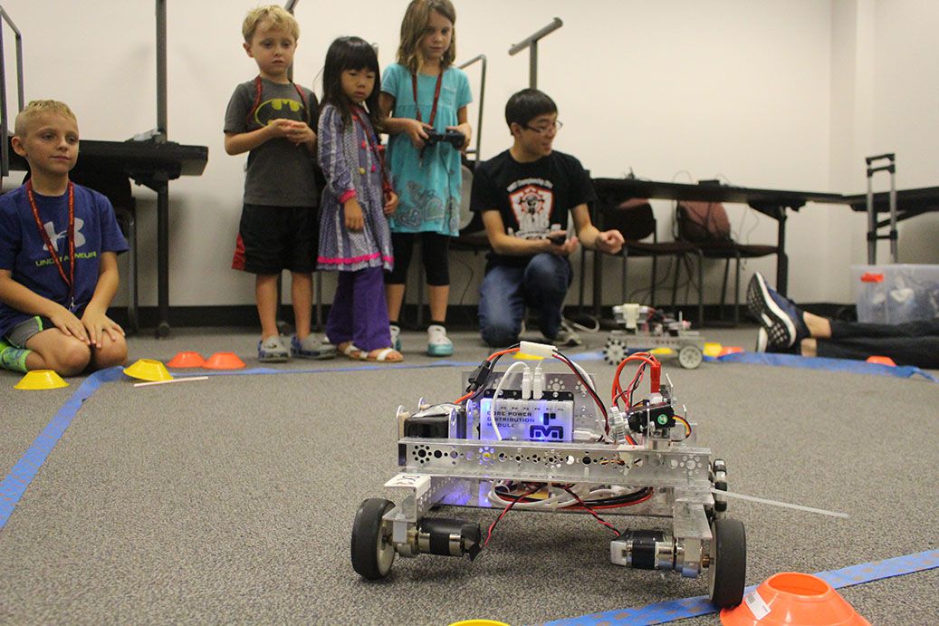 A team member demonstrating a small robot.