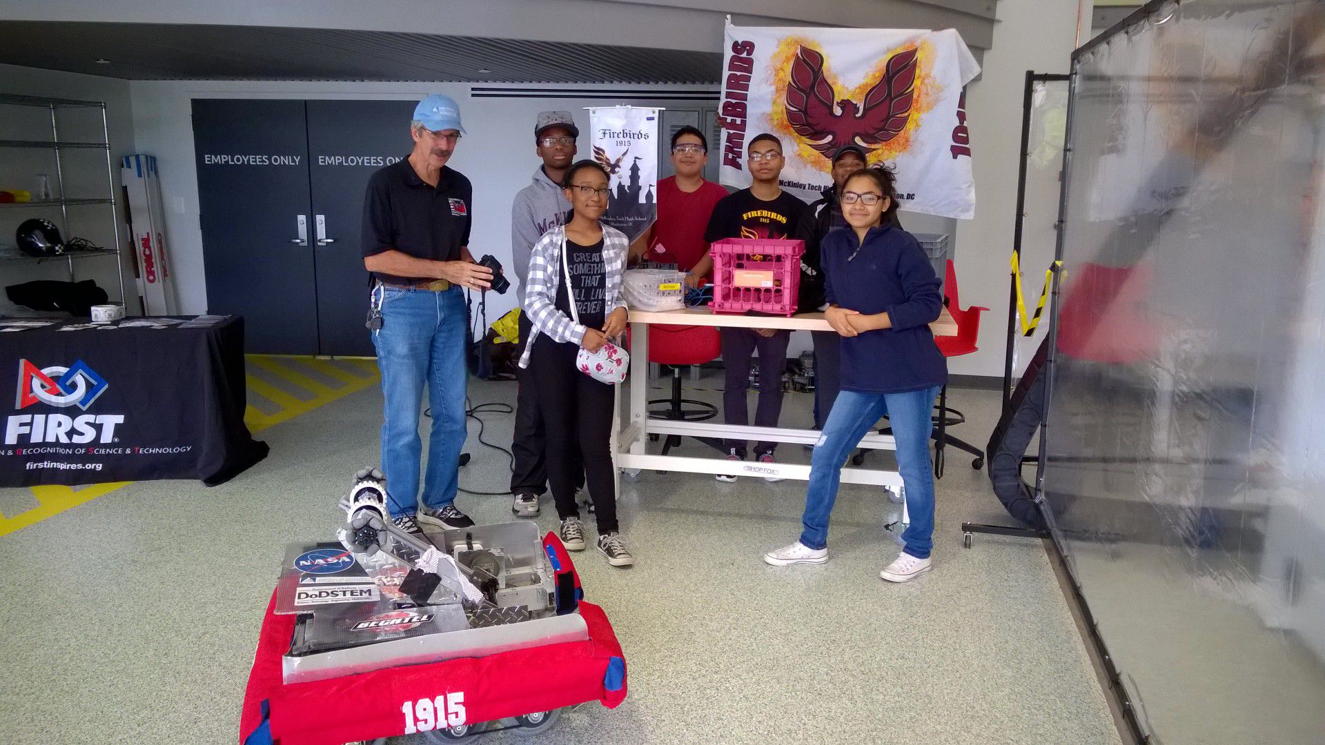 FRC Team 1915 posing behind their robot.